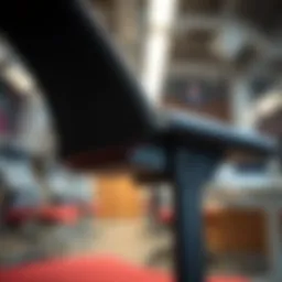 A close-up view of an ergonomic office chair's adjustable armrest showcasing its mechanics.